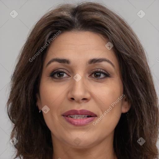 Joyful white adult female with long  brown hair and brown eyes