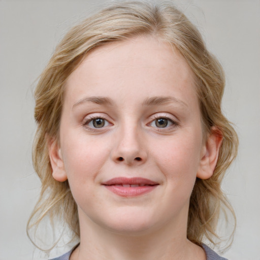 Joyful white child female with medium  brown hair and blue eyes