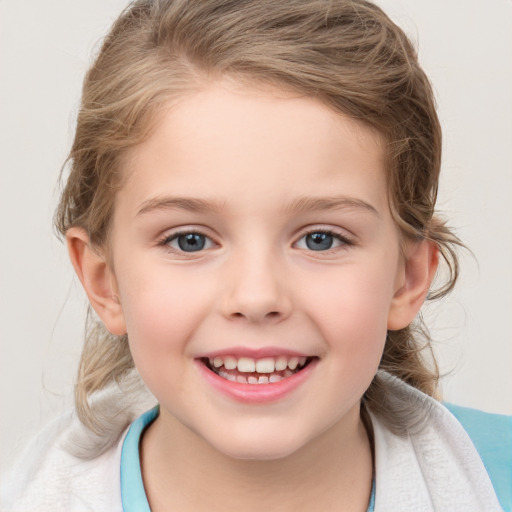 Joyful white child female with medium  brown hair and grey eyes