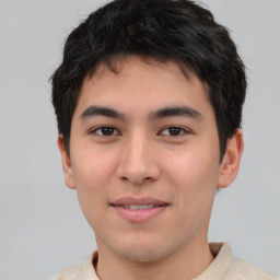 Joyful asian young-adult male with short  brown hair and brown eyes