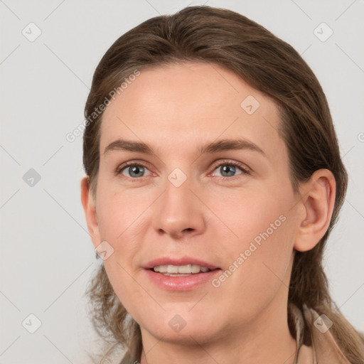 Joyful white young-adult female with medium  brown hair and grey eyes