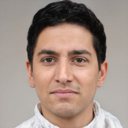 Joyful white young-adult male with short  black hair and brown eyes
