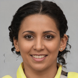 Joyful latino young-adult female with medium  brown hair and brown eyes