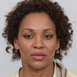 Joyful black adult female with medium  brown hair and brown eyes