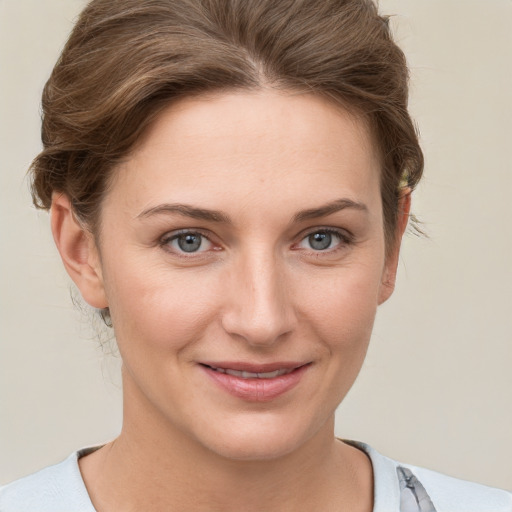 Joyful white young-adult female with short  brown hair and grey eyes