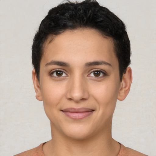 Joyful latino young-adult female with short  brown hair and brown eyes