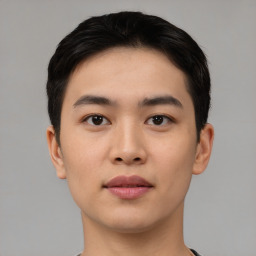 Joyful asian young-adult male with short  black hair and brown eyes