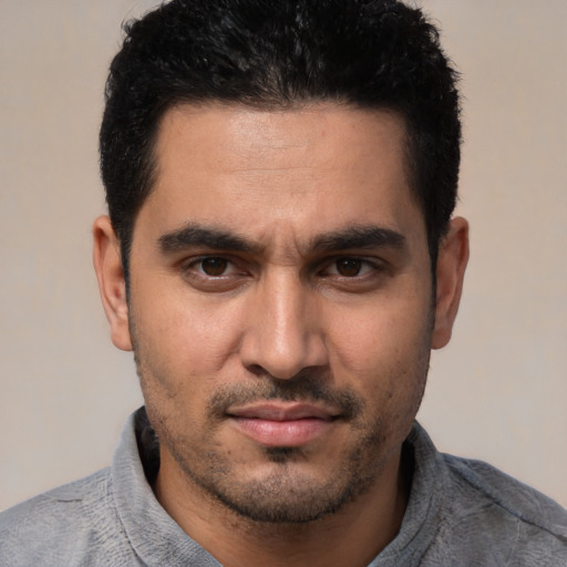 Joyful white young-adult male with short  black hair and brown eyes