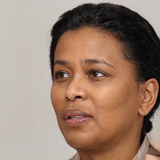 Neutral black adult female with short  black hair and brown eyes
