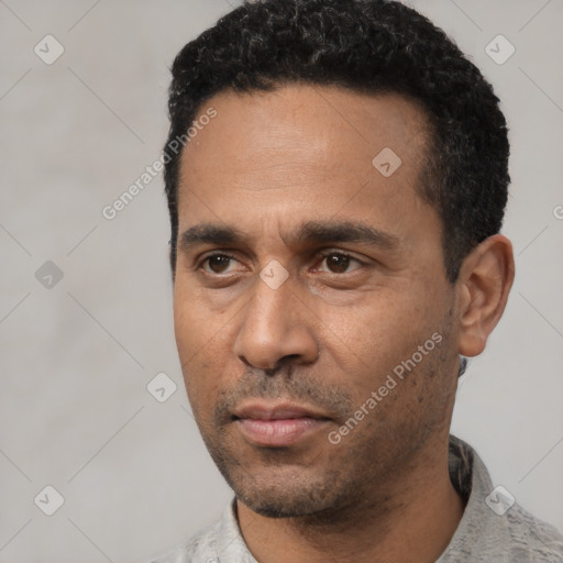 Neutral latino adult male with short  black hair and brown eyes