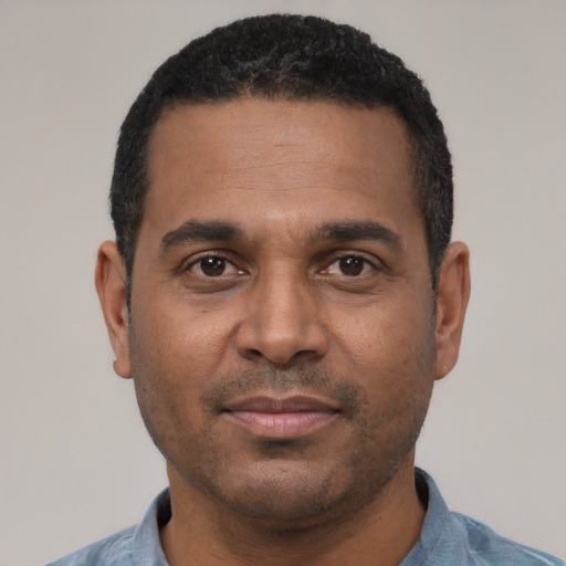 Joyful latino adult male with short  black hair and brown eyes