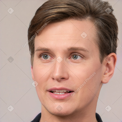 Joyful white young-adult male with short  brown hair and grey eyes