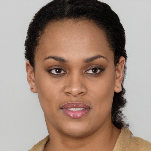 Joyful black young-adult female with short  black hair and brown eyes