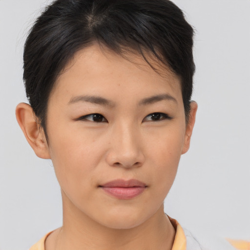 Joyful asian young-adult female with short  brown hair and brown eyes