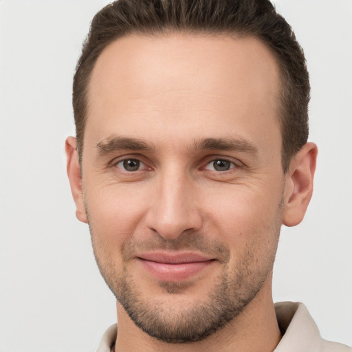 Joyful white young-adult male with short  brown hair and brown eyes