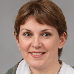 Joyful white adult female with medium  brown hair and grey eyes