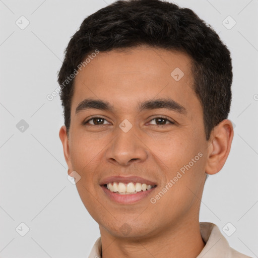 Joyful latino young-adult male with short  brown hair and brown eyes