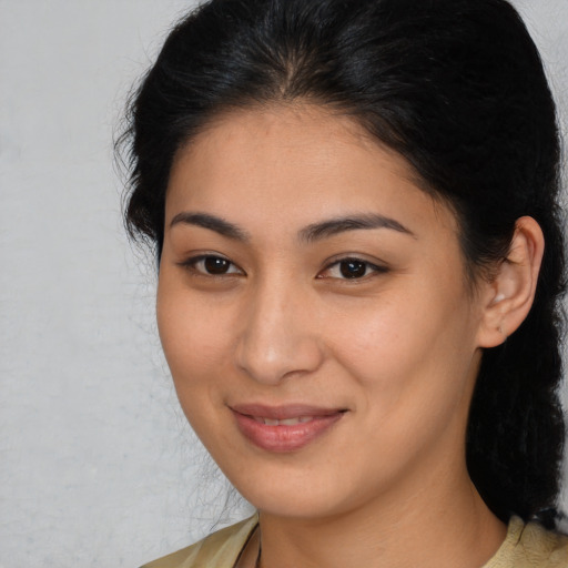 Joyful latino young-adult female with medium  brown hair and brown eyes