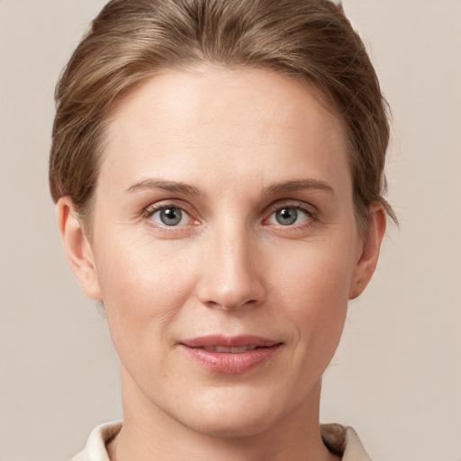 Joyful white young-adult female with short  brown hair and grey eyes