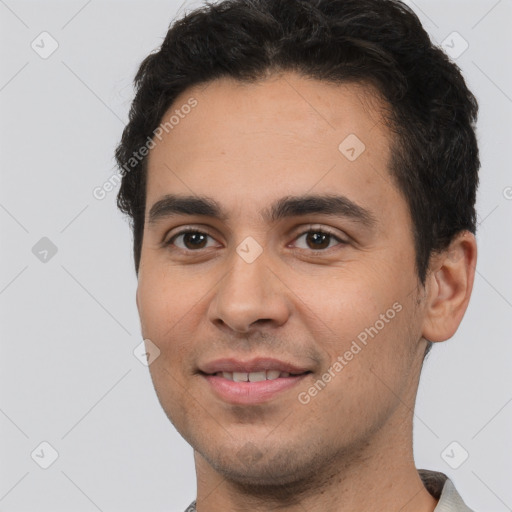 Joyful white young-adult male with short  black hair and brown eyes