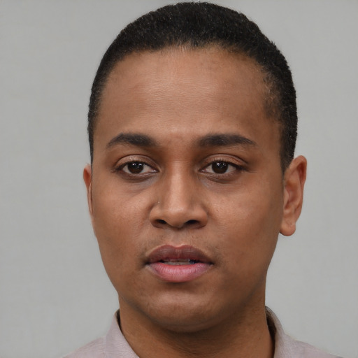 Joyful black young-adult male with short  brown hair and brown eyes