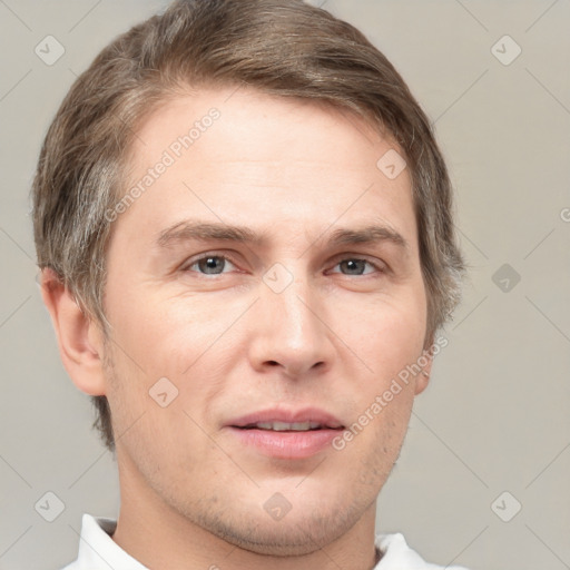 Joyful white adult male with short  brown hair and grey eyes