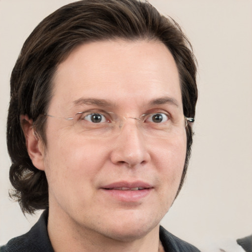 Joyful white adult male with medium  brown hair and grey eyes