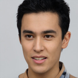 Joyful latino young-adult male with short  brown hair and brown eyes