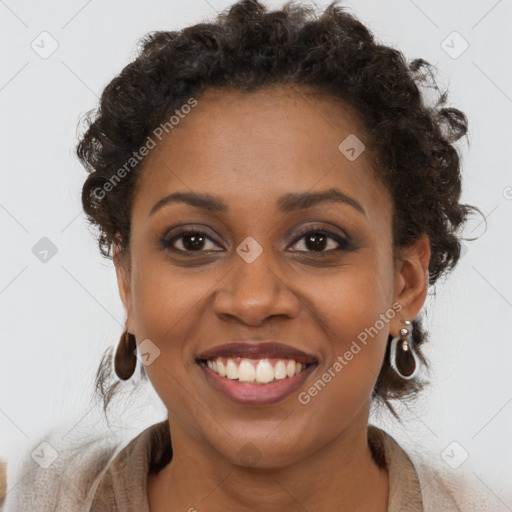 Joyful black young-adult female with long  brown hair and brown eyes