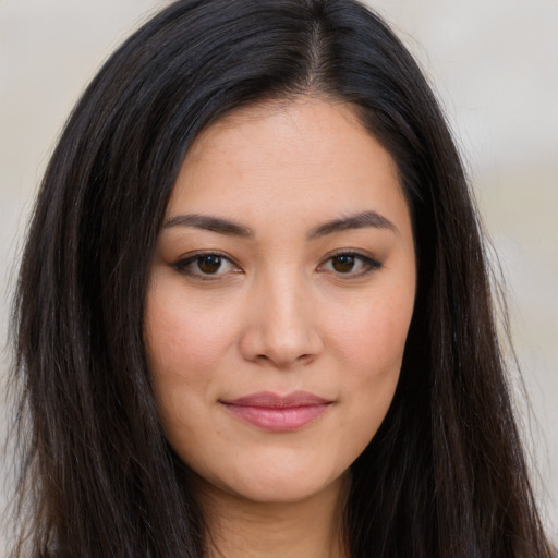 Joyful asian young-adult female with long  brown hair and brown eyes