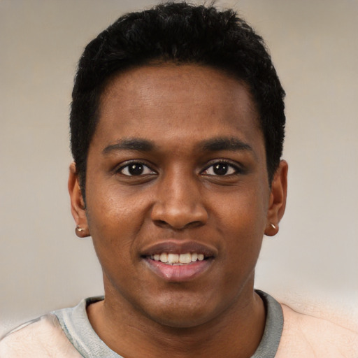 Joyful black young-adult male with short  black hair and brown eyes