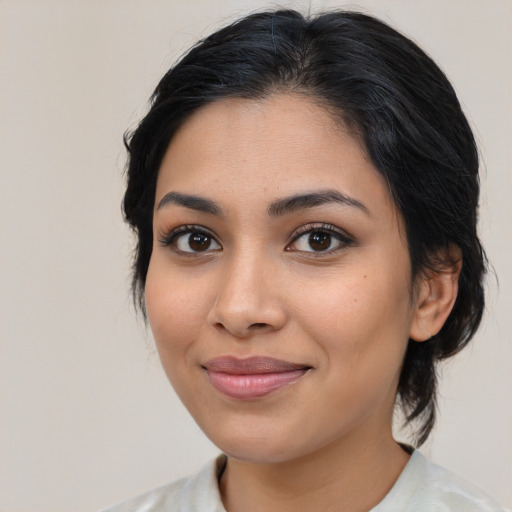 Joyful latino young-adult female with medium  brown hair and brown eyes