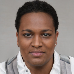 Joyful black young-adult female with short  brown hair and brown eyes