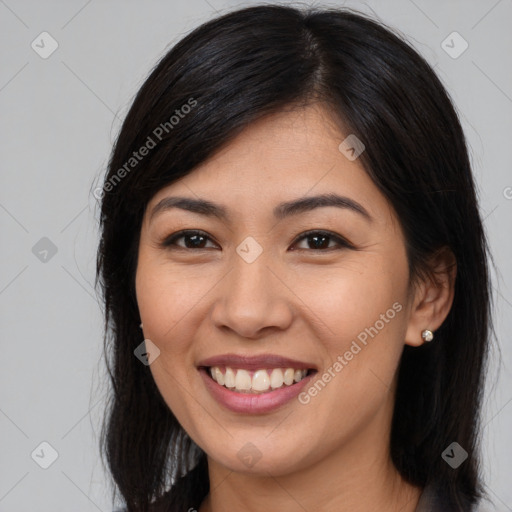 Joyful asian young-adult female with long  brown hair and brown eyes