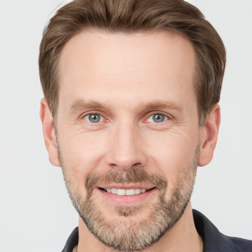 Joyful white adult male with short  brown hair and grey eyes