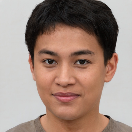 Joyful asian young-adult male with short  brown hair and brown eyes