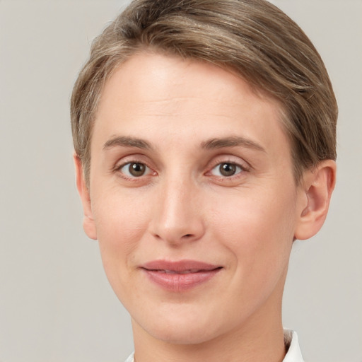 Joyful white young-adult female with short  brown hair and grey eyes