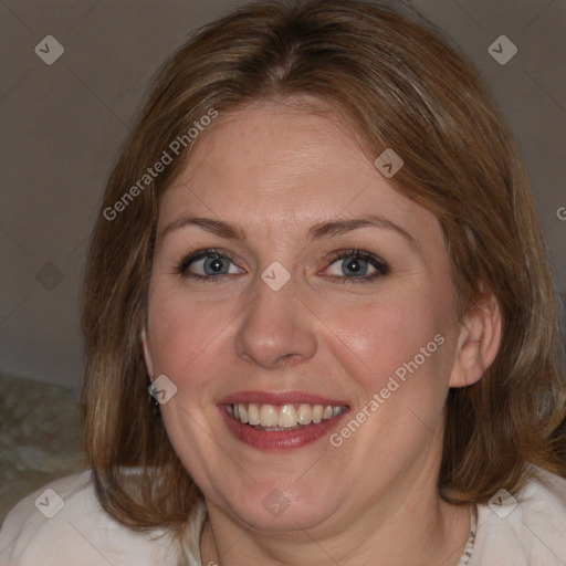 Joyful white adult female with medium  brown hair and blue eyes