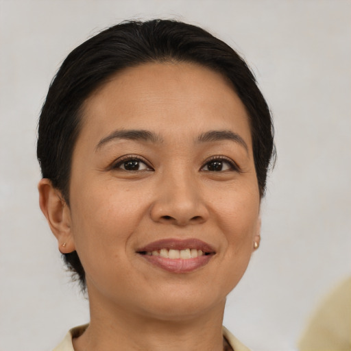 Joyful latino young-adult female with short  brown hair and brown eyes