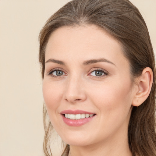 Joyful white young-adult female with long  brown hair and grey eyes