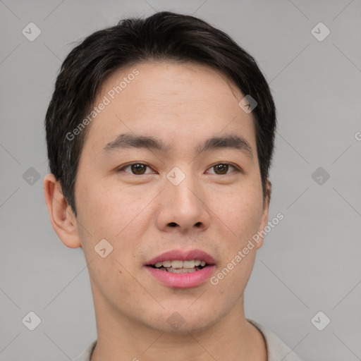 Joyful asian young-adult male with short  brown hair and brown eyes