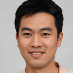 Joyful asian young-adult male with short  black hair and brown eyes