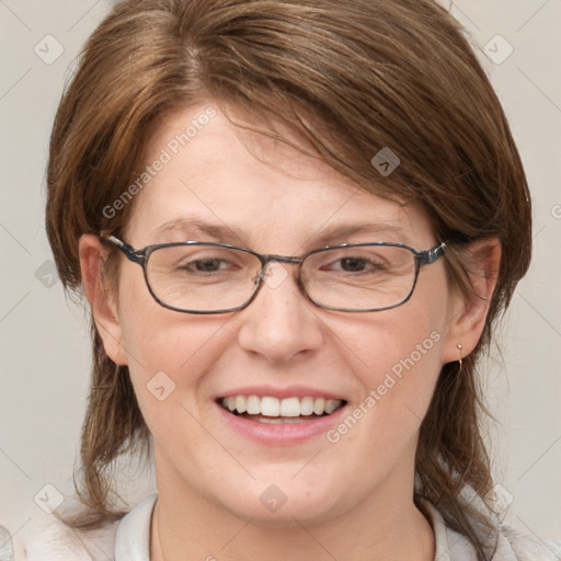 Joyful white adult female with medium  brown hair and blue eyes