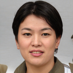 Joyful asian young-adult female with short  brown hair and brown eyes