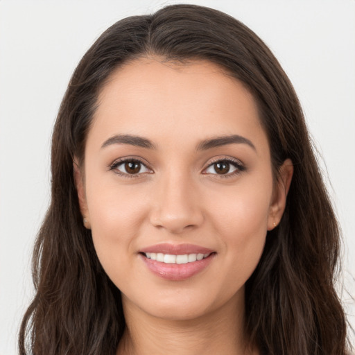 Joyful white young-adult female with long  brown hair and brown eyes