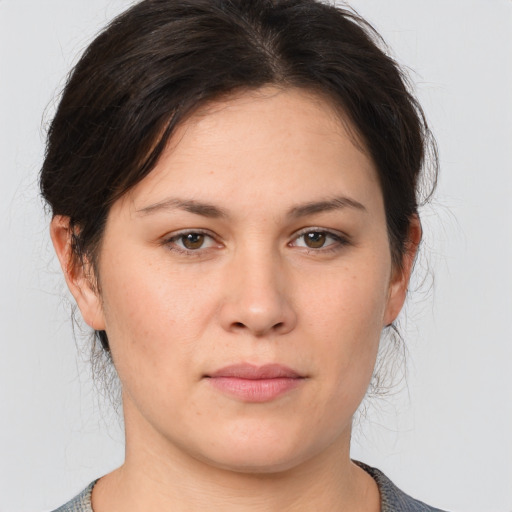 Joyful white young-adult female with medium  brown hair and brown eyes