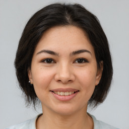 Joyful asian young-adult female with medium  brown hair and brown eyes