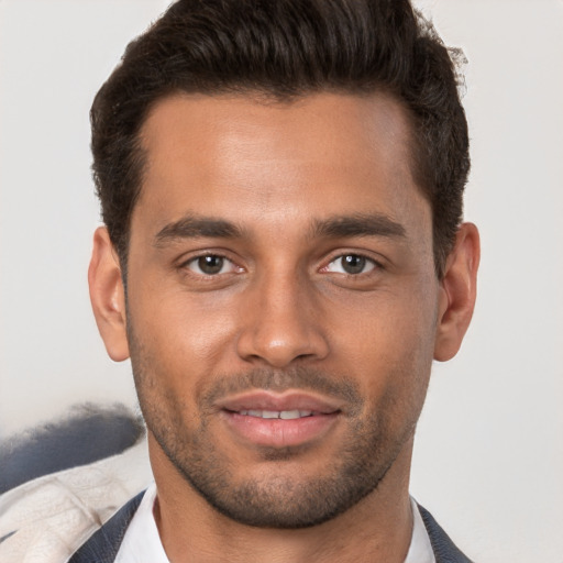 Joyful white young-adult male with short  brown hair and brown eyes