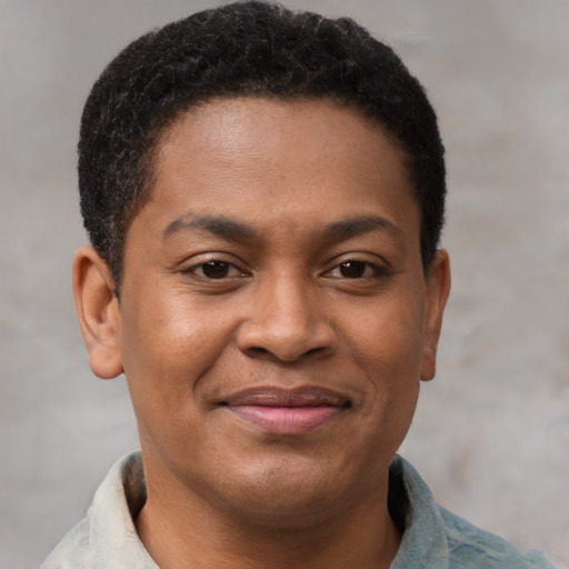 Joyful black young-adult male with short  brown hair and brown eyes
