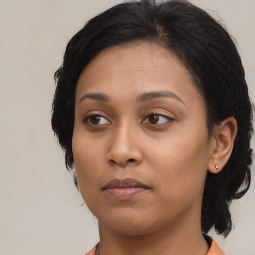 Neutral black young-adult female with medium  black hair and brown eyes